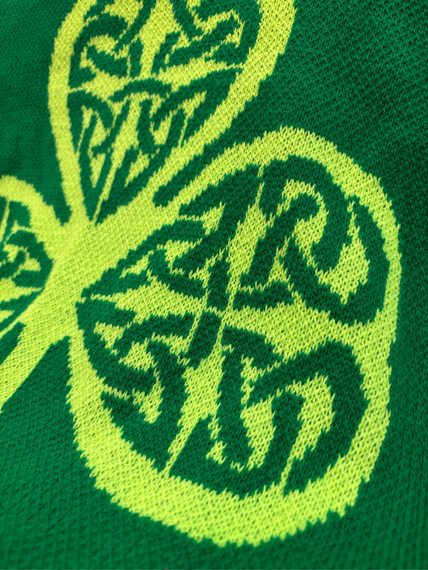 Green and yellow patterned fabric with a leaf design on a green background