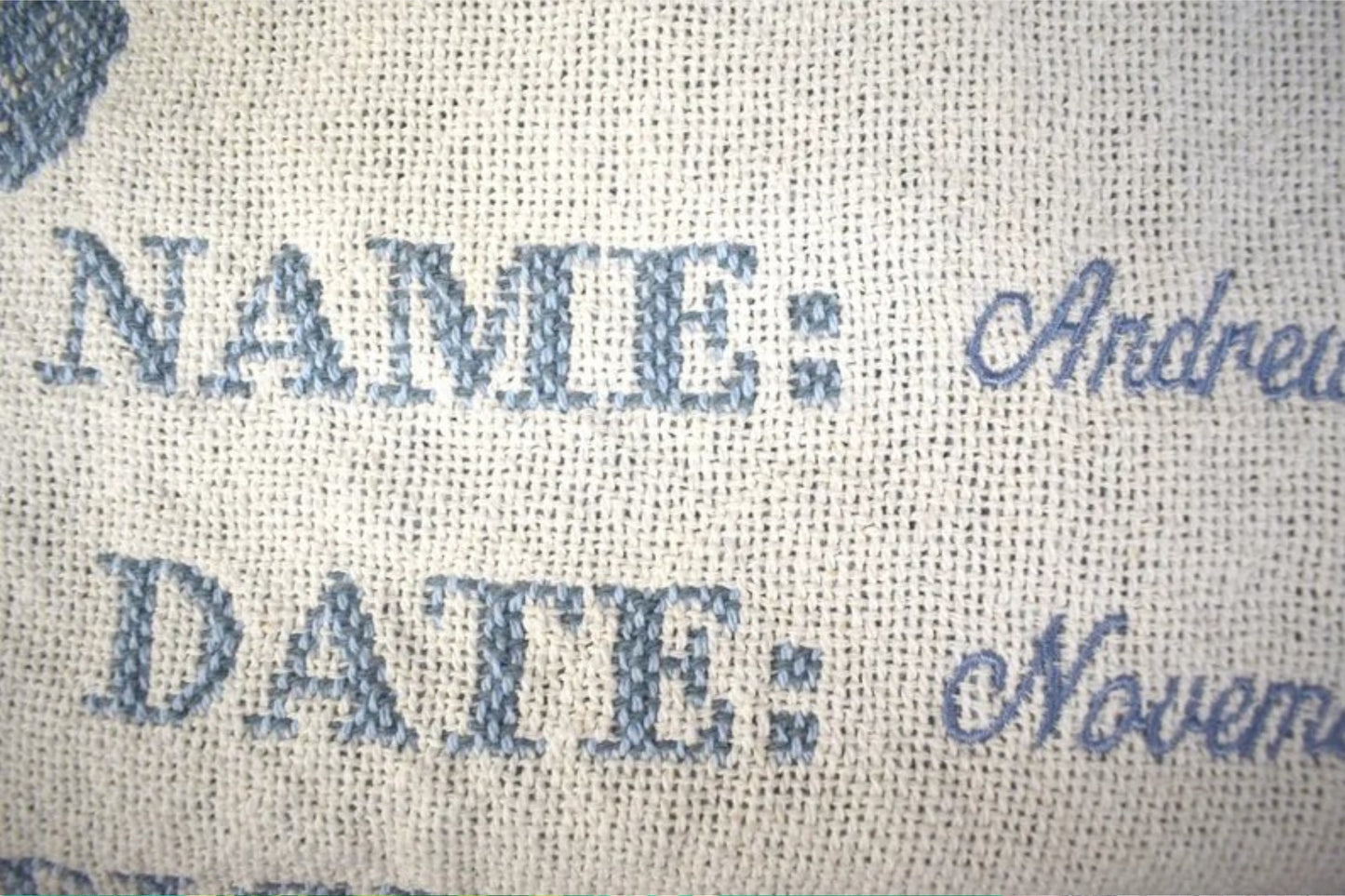 Textured fabric with 'NAME' and 'DATE' printed on it